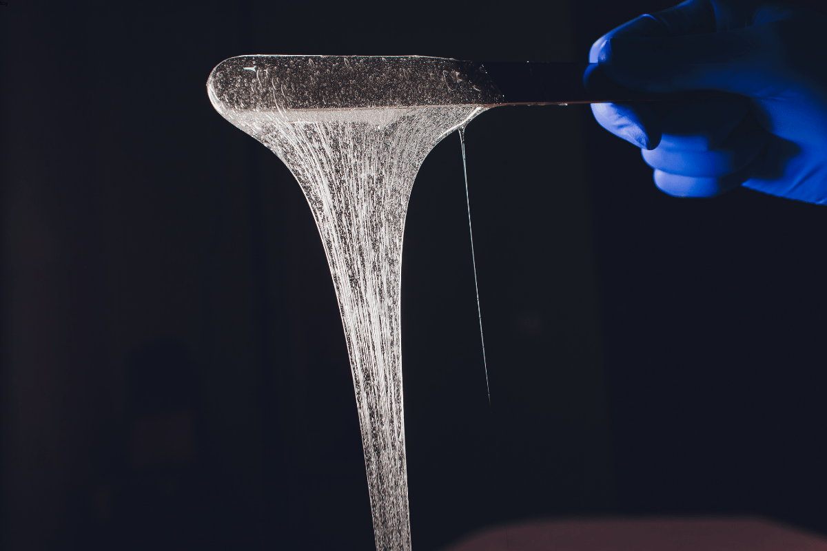 Food-grade water-based adhesive being stretched in lab testing