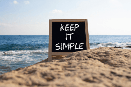 Keep it simple slogan on a chalkboard at the beach, representing streamlined flexible packaging orders