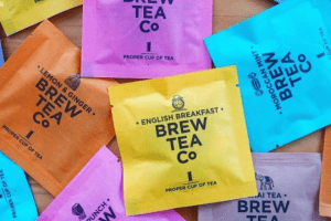 Custom tea bag packaging in a variety of vibrant colors, made from laminated paper roll material.