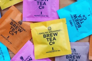 Custom tea bag packaging in a variety of vibrant colors, made from laminated paper roll material.