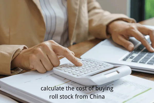 Businessperson using a calculator and laptop to estimate the total cost of purchasing laminated roll stock packaging from China.