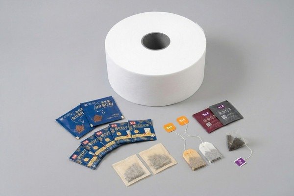 Custom tea bag packaging materials from XLD including tea bag filter roll, tea bag envelopes, tea bag tags, and finished tea bags