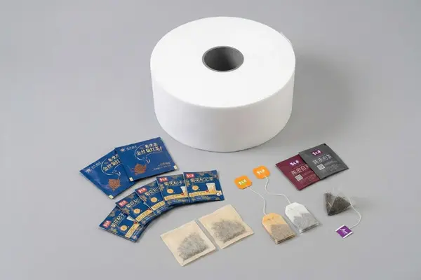 Custom tea bag packaging materials from XLD including tea bag filter roll, tea bag envelopes, tea bag tags, and finished tea bags