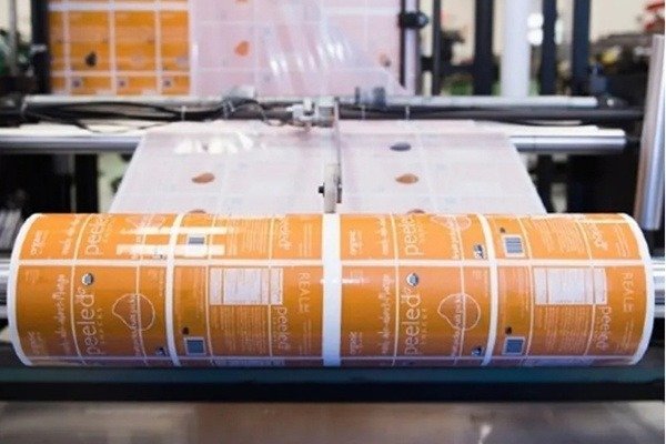 Custom printed rollstock film on converting machine ready for VFFS pouch production
